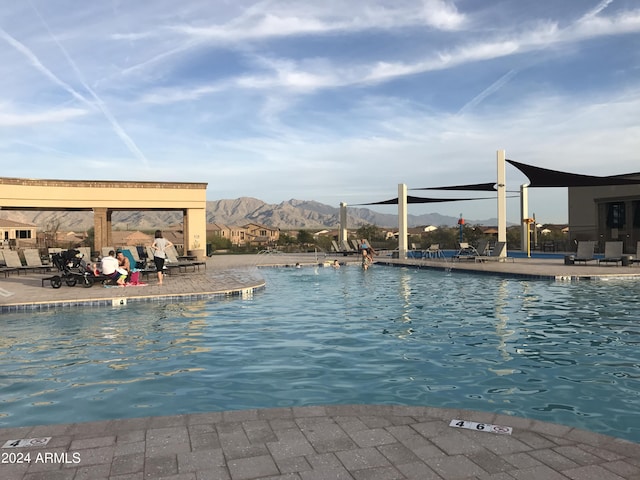 view of pool featuring a mountain view and a patio