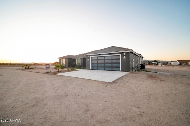 22548 W Huntington Dr, Buckeye, AZ 85326 - view of front of house featuring stucco siding, a tile roof, cooling unit, and a garage
