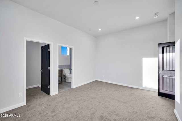 22548 W Huntington Dr, Buckeye, AZ 85326 - unfurnished bedroom featuring carpet flooring, baseboards, recessed lighting, connected bathroom, and a walk in closet