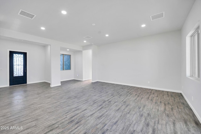 22548 W Huntington Dr, Buckeye, AZ 85326 - unfurnished living room featuring recessed lighting, baseboards, and wood finished floors