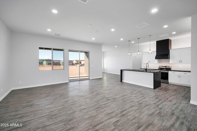22548 W Huntington Dr, Buckeye, AZ 85326 - kitchen with stainless steel electric range oven, dark countertops, open floor plan, a sink, and recessed lighting