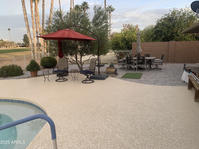 view of swimming pool with a fenced in pool, a patio area, a fenced backyard, and outdoor dining area