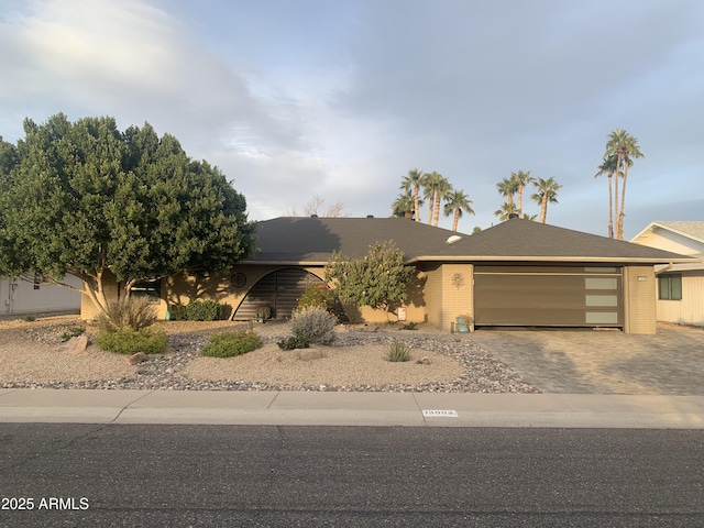 view of front of home with decorative driveway and an attached garage