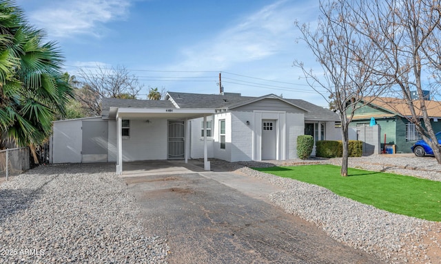 single story home featuring a carport