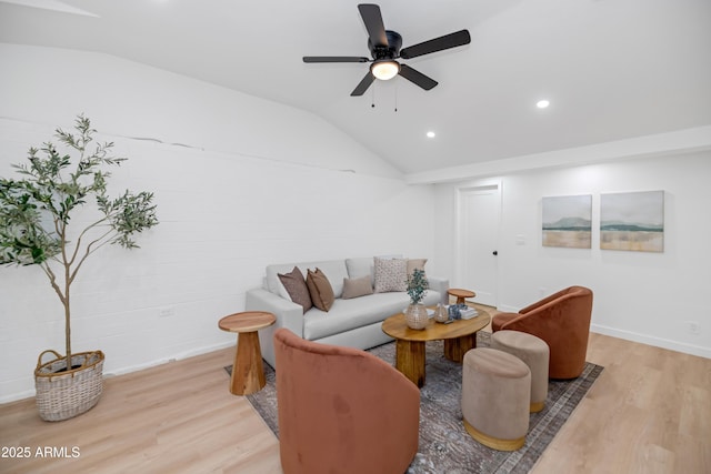 living room featuring ceiling fan, lofted ceiling, and light hardwood / wood-style floors