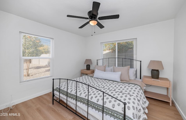 bedroom with light wood-type flooring and ceiling fan