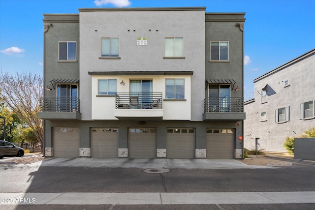 exterior space with a garage and stucco siding