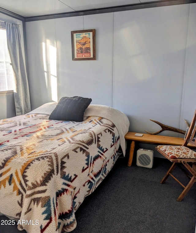 bedroom featuring multiple windows and carpet flooring