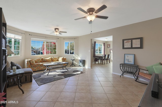 tiled living room featuring ceiling fan