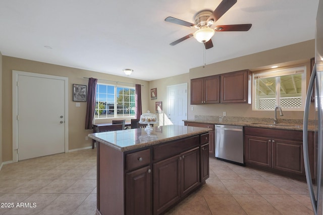 kitchen with sink, a center island, dishwasher, and light tile patterned flooring