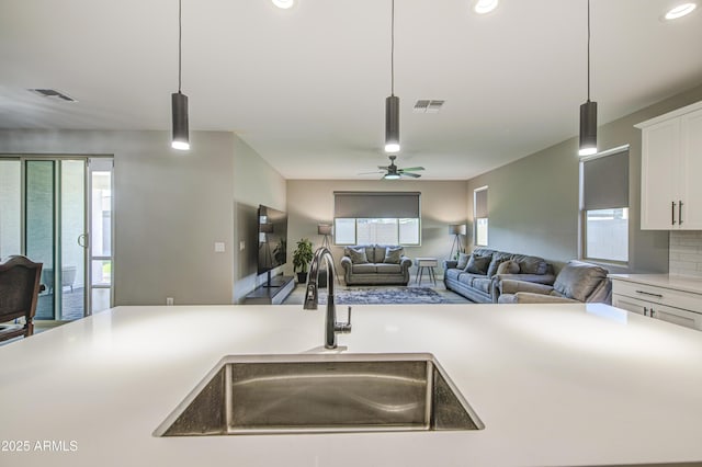 12806 W Mclellan Rd, Glendale, AZ 85307 - kitchen with light countertops, white cabinetry, recessed lighting, hanging light fixtures, and open floor plan