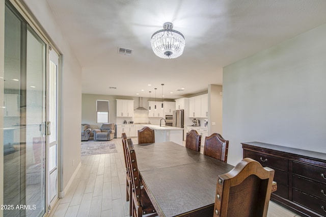 12806 W Mclellan Rd, Glendale, AZ 85307 - dining room featuring a chandelier and light wood-type flooring