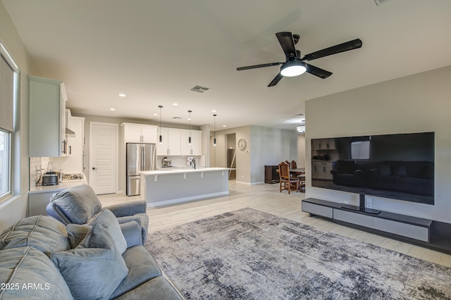 12806 W Mclellan Rd, Glendale, AZ 85307 - living room featuring light wood-style flooring, a ceiling fan, and recessed lighting