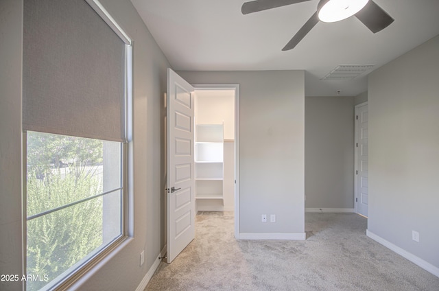 12806 W Mclellan Rd, Glendale, AZ 85307 - unfurnished bedroom with a walk in closet, carpet floors, a closet, and ceiling fan