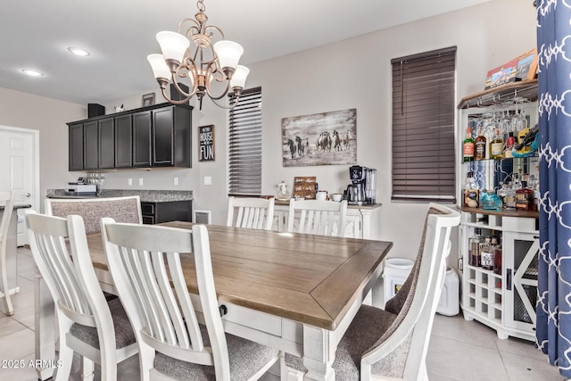 dining area with an inviting chandelier and light tile patterned floors