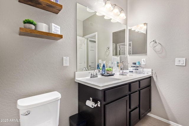 bathroom with vanity, tile patterned floors, and toilet