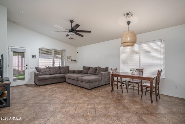living area featuring ceiling fan, visible vents, and vaulted ceiling