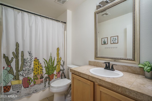 bathroom with vanity, toilet, and visible vents
