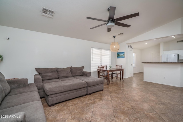 living room featuring a ceiling fan, visible vents, and lofted ceiling