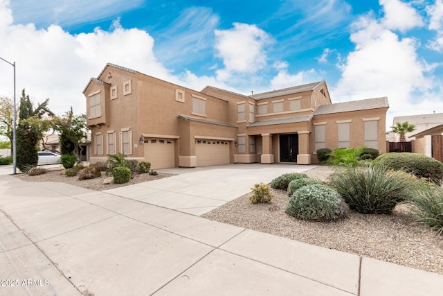 view of front of property featuring driveway, a garage, and stucco siding