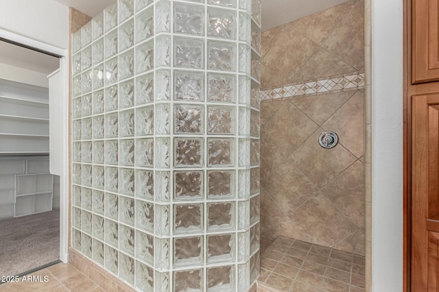 bathroom with a walk in shower and tile patterned floors