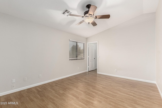 spare room with lofted ceiling, visible vents, ceiling fan, light wood-type flooring, and baseboards