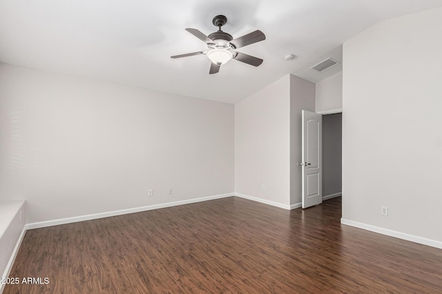 empty room featuring a ceiling fan, dark wood-style flooring, visible vents, and baseboards