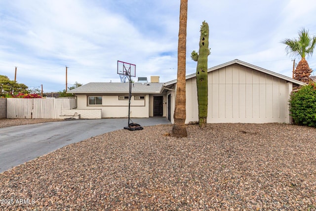 view of front of home with fence and concrete driveway