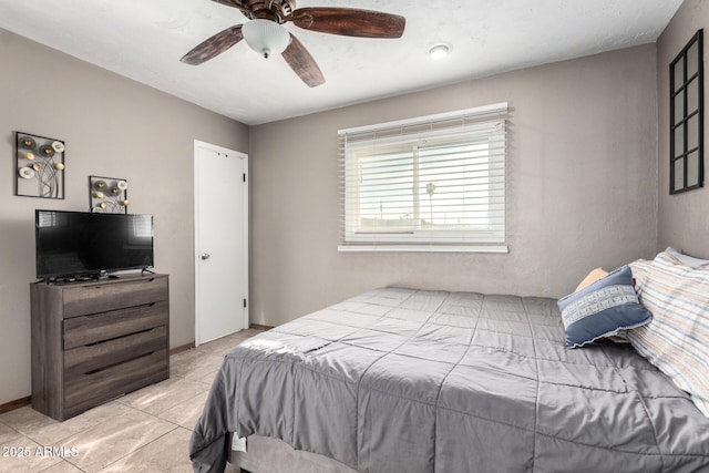 bedroom featuring a ceiling fan and light tile patterned floors