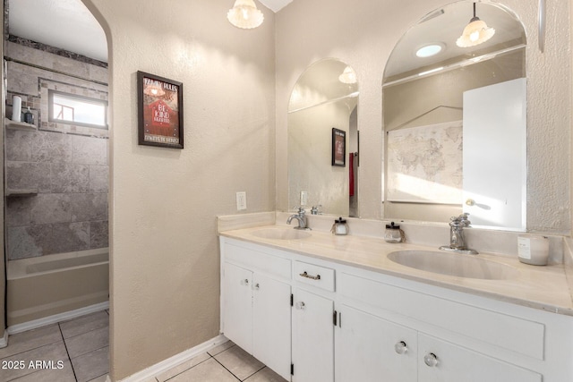 full bathroom featuring a sink, tile patterned flooring, double vanity, and  shower combination