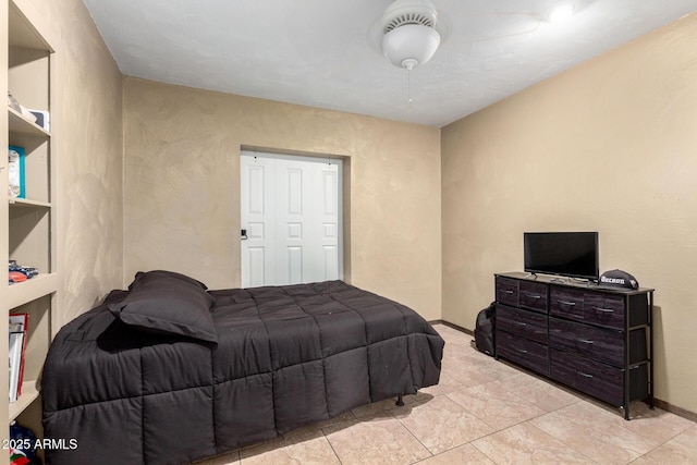 bedroom featuring baseboards and ceiling fan
