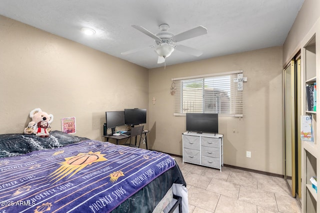 bedroom featuring baseboards and a ceiling fan