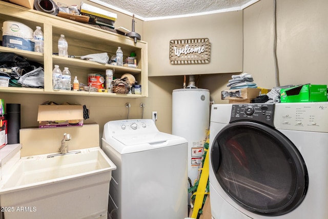 laundry area with independent washer and dryer, laundry area, a sink, gas water heater, and a textured ceiling