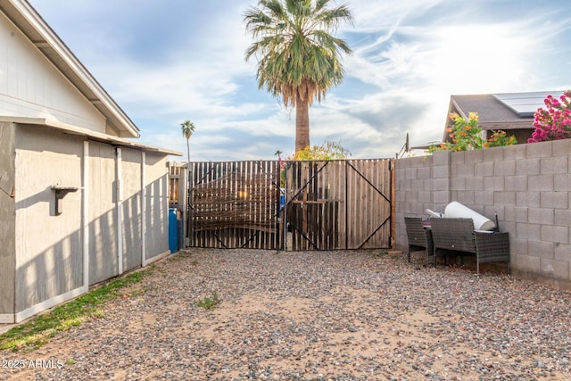 view of gate with a fenced backyard