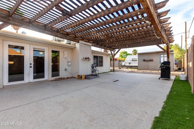 view of patio / terrace with grilling area, a pergola, fence, and french doors