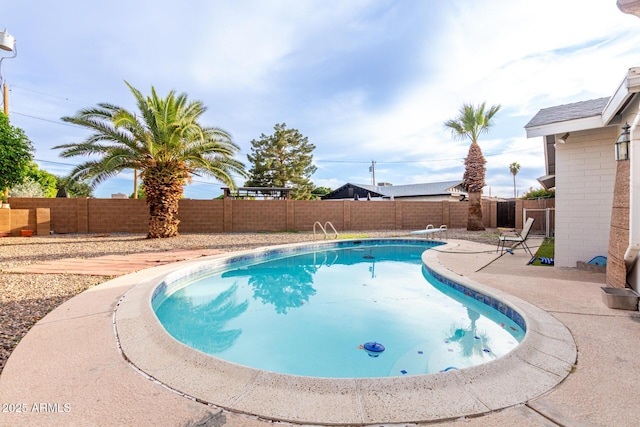view of pool featuring a patio, a fenced in pool, and a fenced backyard