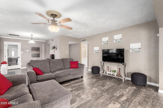 living room featuring baseboards, visible vents, ceiling fan, and wood finished floors