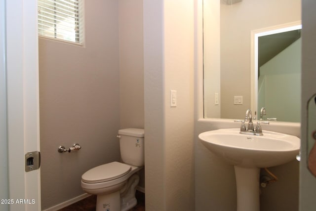 bathroom featuring toilet and sink