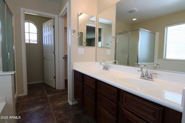 bathroom featuring vanity and a shower with door