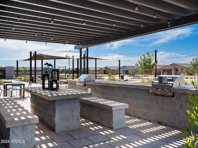 view of patio / terrace with grilling area, an outdoor kitchen, and an outdoor bar