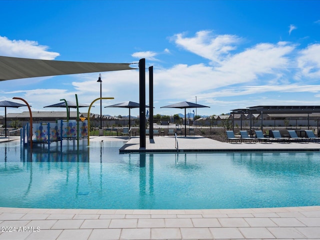 community pool with fence and a patio