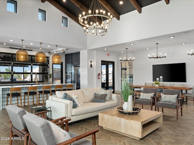 living room featuring beam ceiling, a healthy amount of sunlight, a high ceiling, and an inviting chandelier