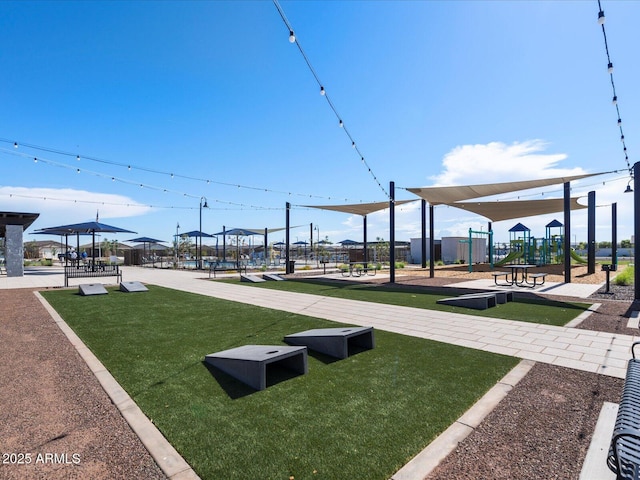 view of property's community featuring playground community and a lawn