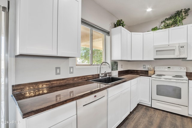 kitchen with dark hardwood / wood-style floors, white cabinetry, white appliances, and sink