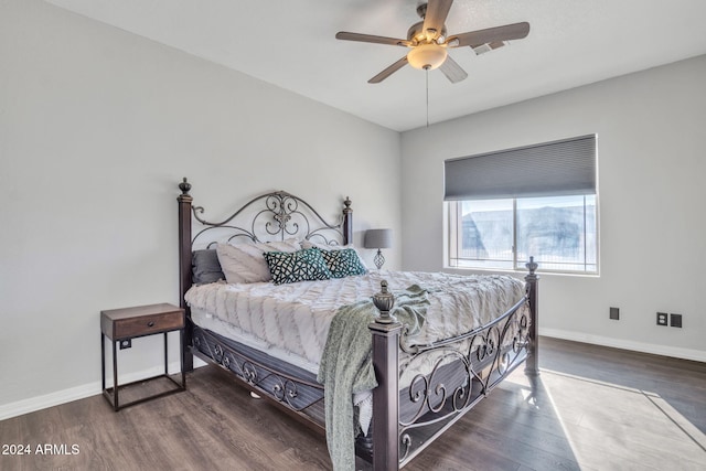 bedroom with dark hardwood / wood-style flooring and ceiling fan