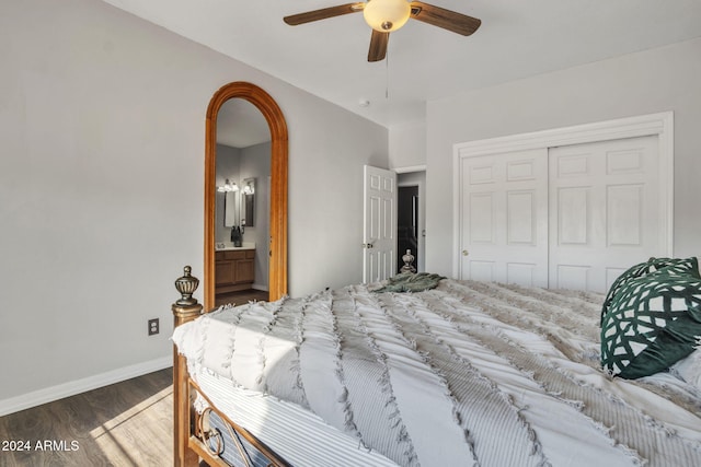 bedroom with ensuite bath, ceiling fan, a closet, and dark hardwood / wood-style flooring