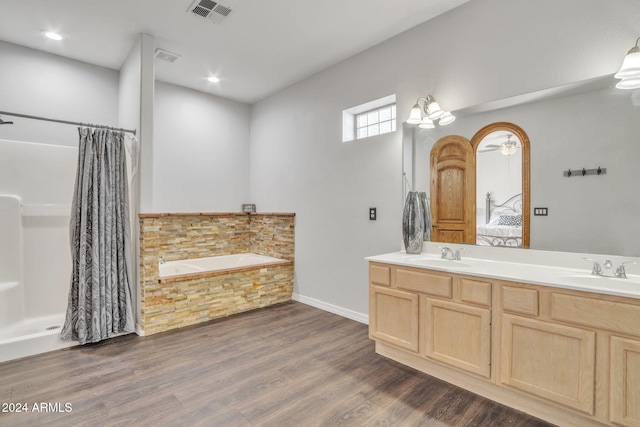 bathroom featuring vanity, hardwood / wood-style flooring, separate shower and tub, and ceiling fan