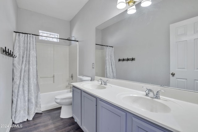 full bathroom with hardwood / wood-style flooring, vanity, toilet, and shower / bath combo with shower curtain