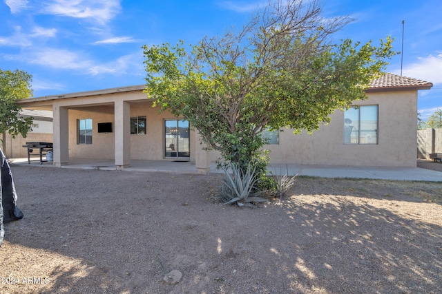 rear view of property featuring a patio