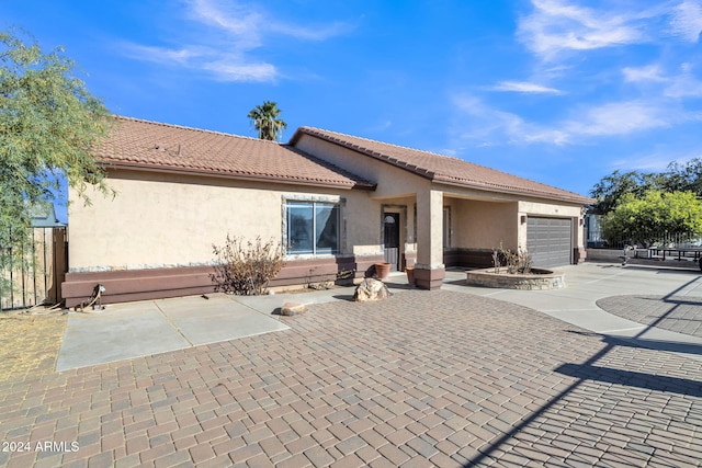 rear view of property featuring a garage